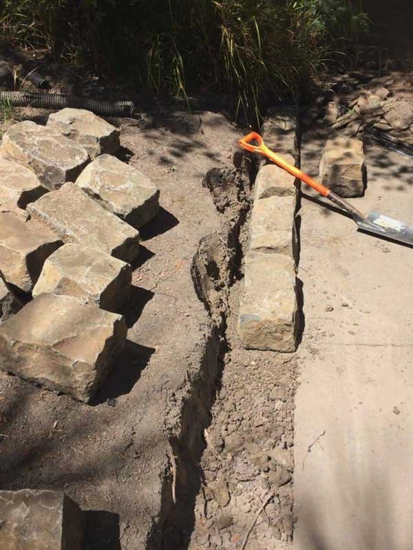 bluestone kerb stones being laid into our landscape and garden installation  